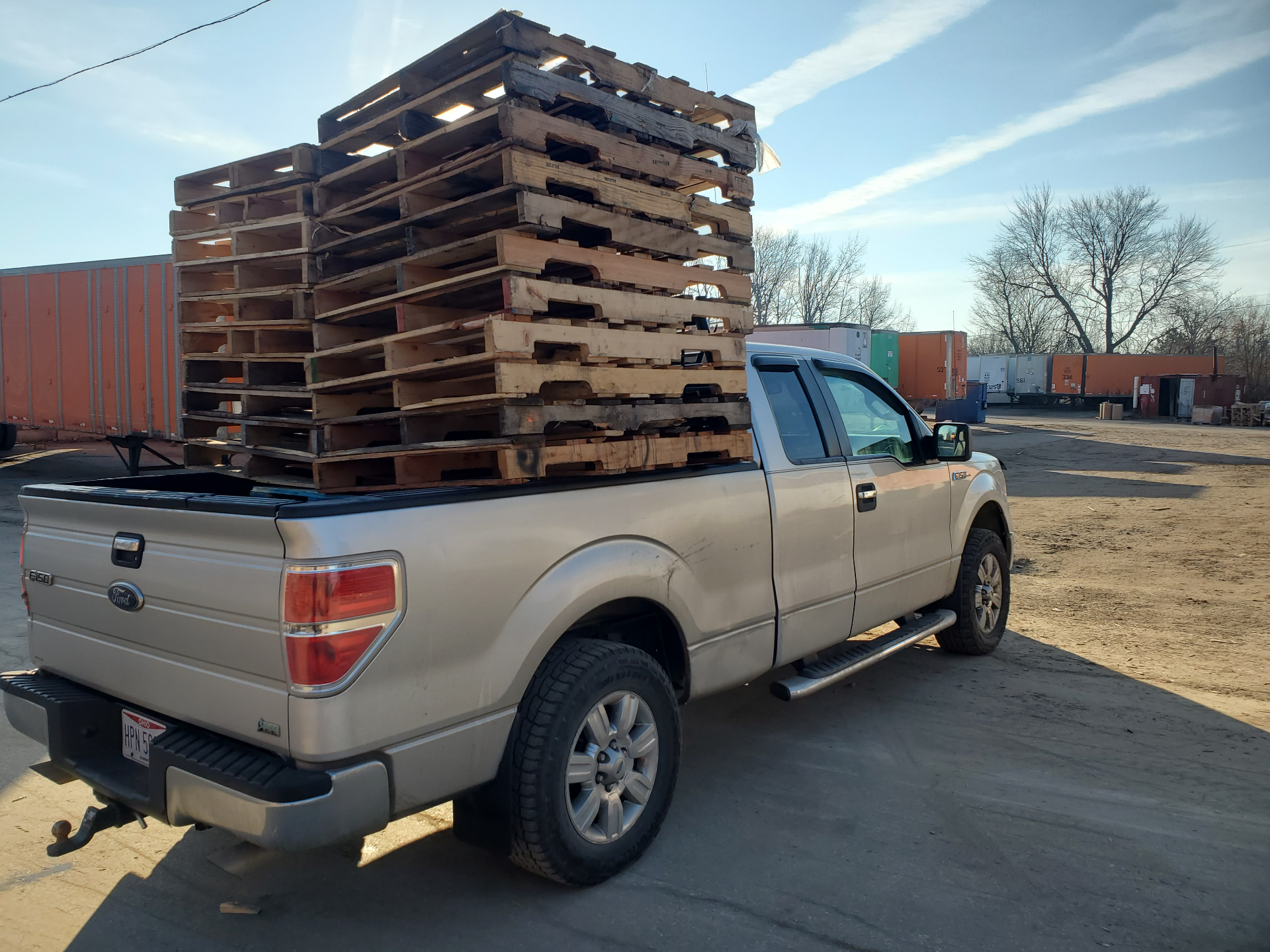 Pickup truck stacked with pallets at the buying yard