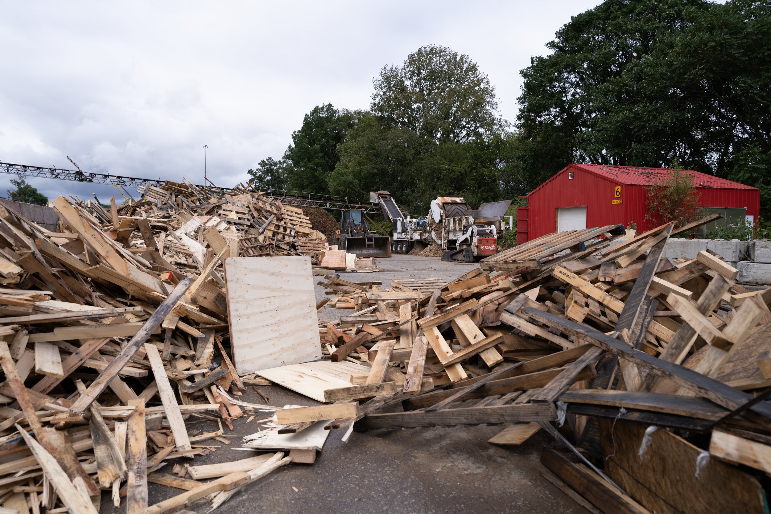 Piles of broken pallets and wood pieces at TCP's Akron yard